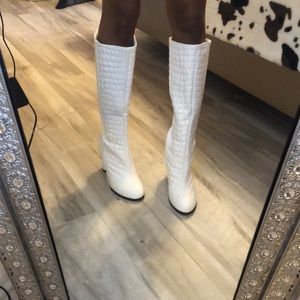White textured knee high boots.